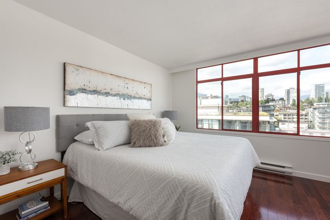 Bedroom with a city view, multiple windows, and baseboard heating | Image 22
