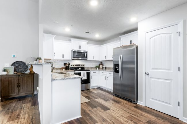 Beautiful kitchen with lots of cabinets, stainless steel appliances and a large pantry. | Image 13