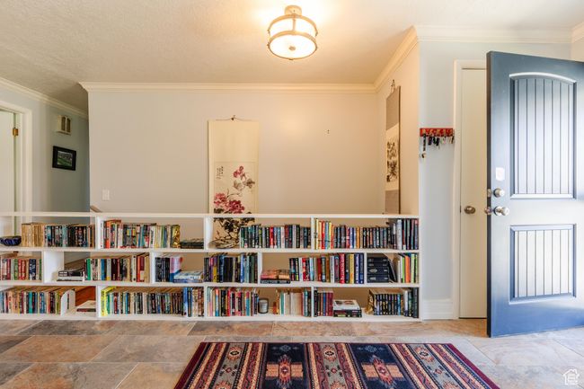 Interior space featuring stone finish floor and ornamental molding | Image 14