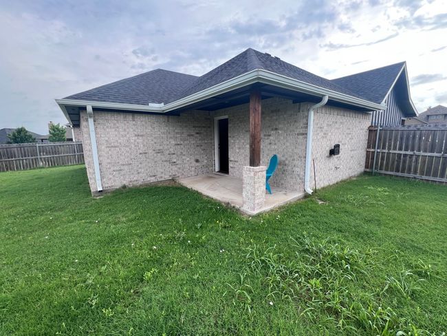 Rear view of property with roof with shingles, brick siding, and a patio area | Image 22