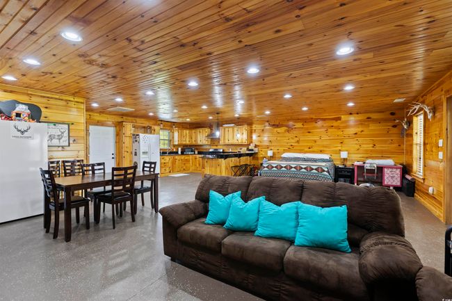 Living area featuring wood walls and recessed lighting | Image 29