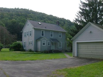 View of front facade with a garage, a mountain view, and a front yard | Image 3