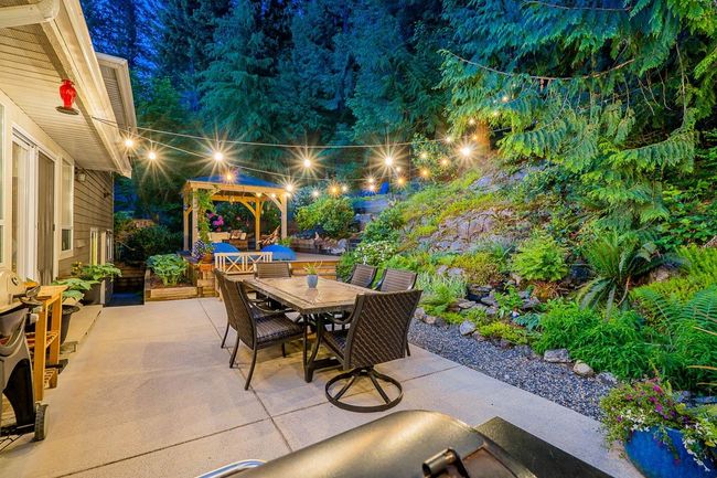 Patio at night with a gazebo, outdoor dining area, and a patio area | Image 24