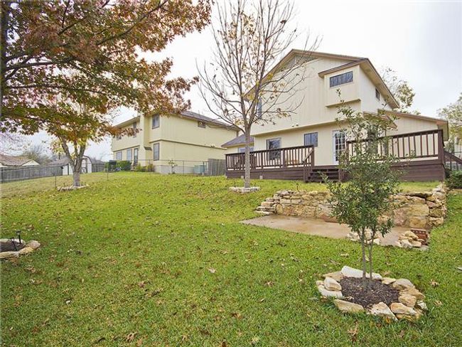 View of yard featuring a deck, fence, and a patio | Image 12