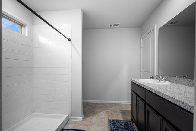 Bathroom featuring vanity, a stall shower, and visible vents | Image 17