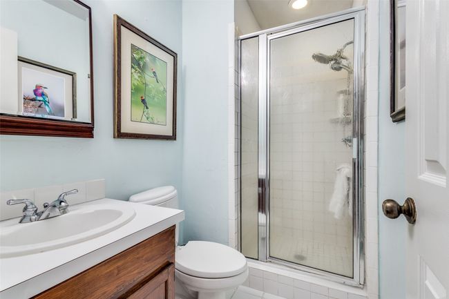 Full bathroom with toilet, vanity, and a stall shower | Image 20