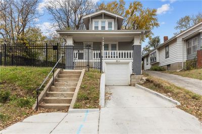 Bungalow-style house featuring covered porch and a garage | Image 1