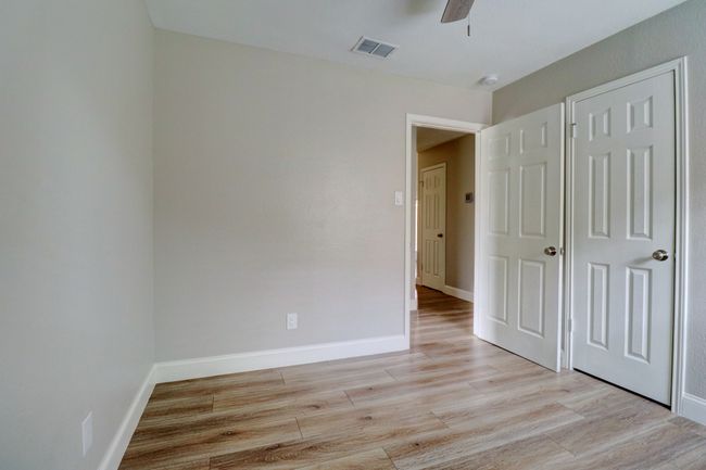 Unfurnished bedroom featuring light wood-style flooring and a ceiling fan | Image 20