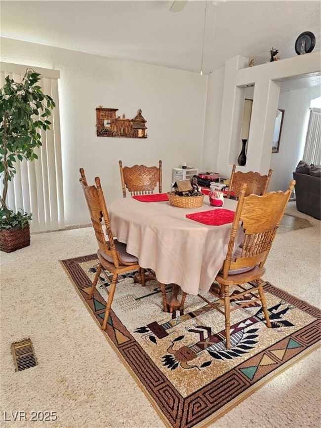 Dining space with speckled floor and visible vents | Image 24
