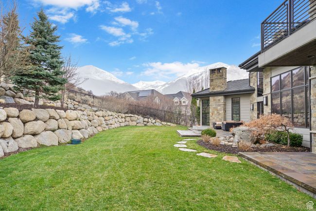 View of yard with a mountain view, fence, a patio, and a balcony | Image 109