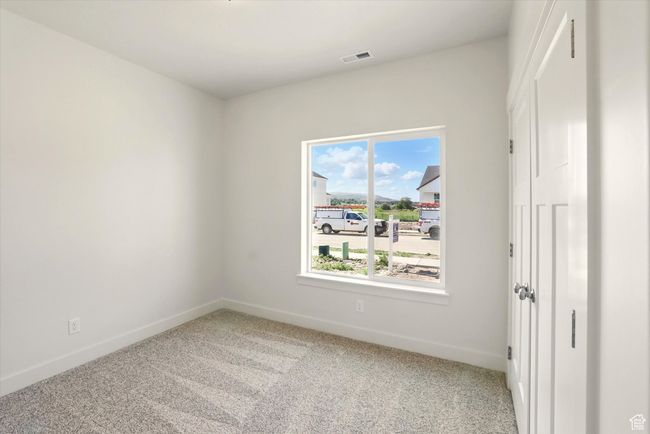 Carpeted empty room featuring baseboards | Image 28