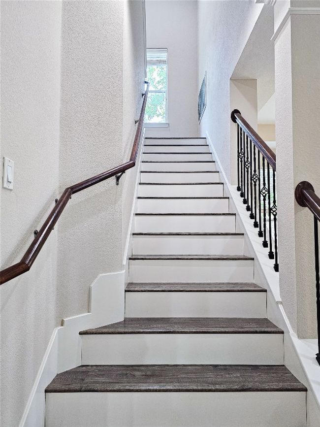 Staircase featuring a textured wall | Image 16