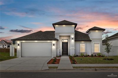 View of front of property with a yard and a garage | Image 1