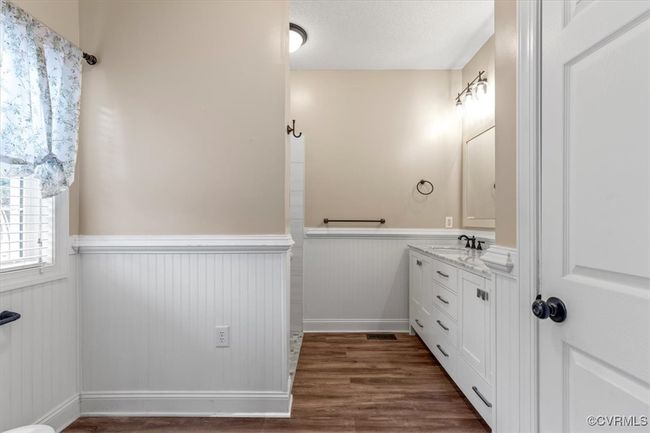 Bathroom with wainscoting, wood finished floors, and vanity | Image 32