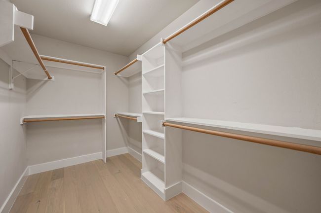 Walk in closet with wood finished floors | Image 25