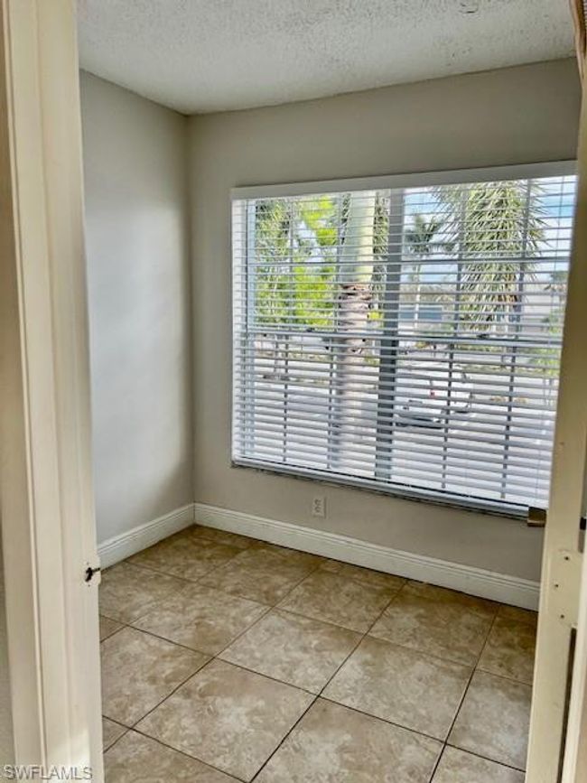 Empty room featuring light tile patterned floors, a textured ceiling, baseboards, and a healthy amount of sunlight | Image 20