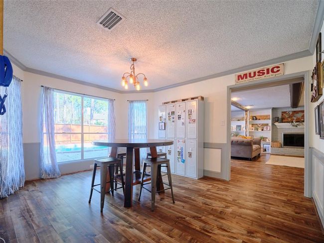 The large bay windows in this bonus breakfast/dining room invite natural light and provide a perfect view of the beautiful pool. | Image 9