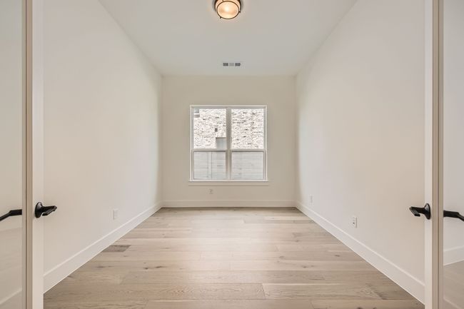 Spare room featuring french doors, light wood finished floors, and baseboards | Image 15