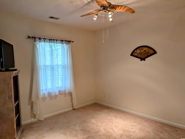 Spare room with light carpet, baseboards, visible vents, and a ceiling fan | Image 14