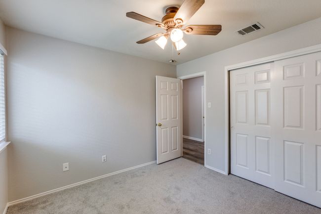 Bed #2 Unfurnished bedroom featuring carpet flooring, a closet, and a ceiling fan | Image 25