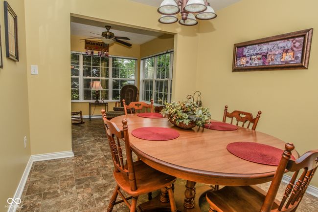 dining space featuring baseboards, a chandelier | Image 7