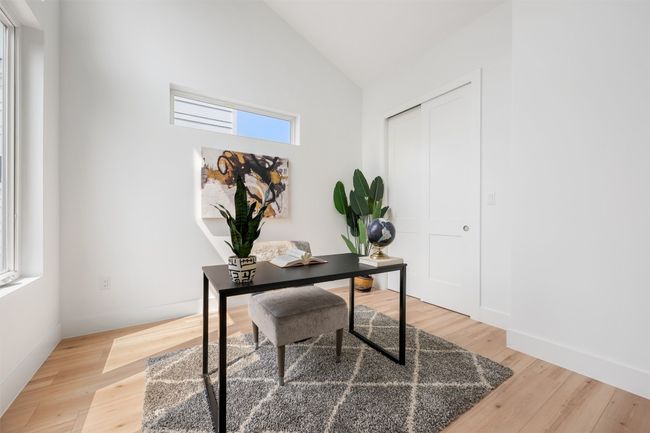 Office area featuring light wood-type flooring, high vaulted ceiling, and baseboards | Image 21