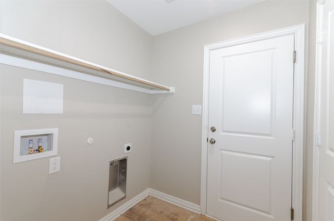 Laundry room with electric dryer hookup, light wood-style floors, baseboards, hookup for a washing machine, and laundry area | Image 20