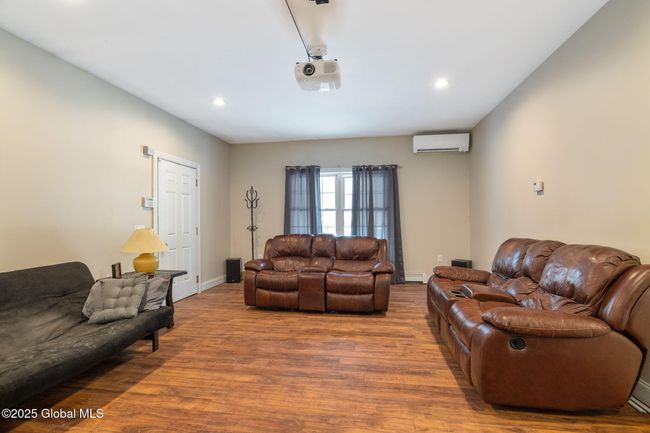 First floor Family Room, currently used as a media room with door to garage | Image 17