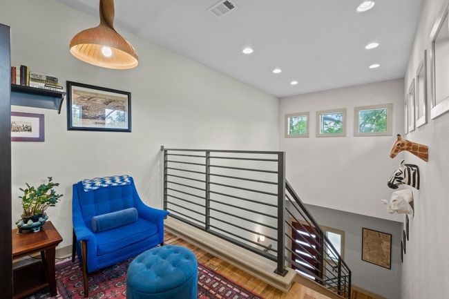 Sitting room with an upstairs landing, wood finished floors, visible vents, and recessed lighting | Image 18