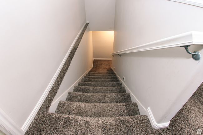 Stairs featuring carpet flooring going downstairs to the family room or/AUD. | Image 21