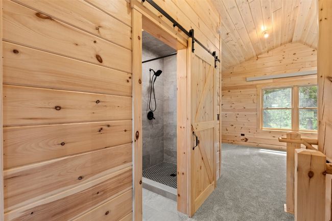 Hallway to upstairs bath with a barn door closure | Image 34
