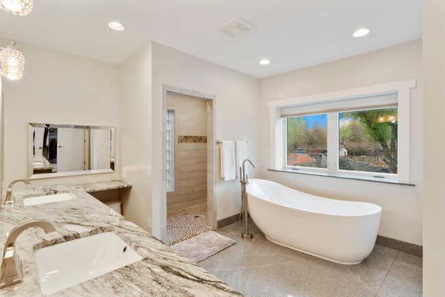 Fully tiled shower along with a deep soaking tub complete this gorgeous bathroom | Image 23