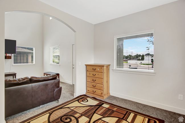 Living area with carpet and arched walkways | Image 10