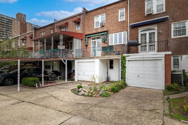 View of front of house featuring driveway, a garage, central AC, and brick siding | Image 16