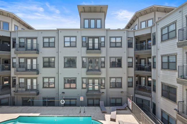 View of building exterior featuring a community pool | Image 23