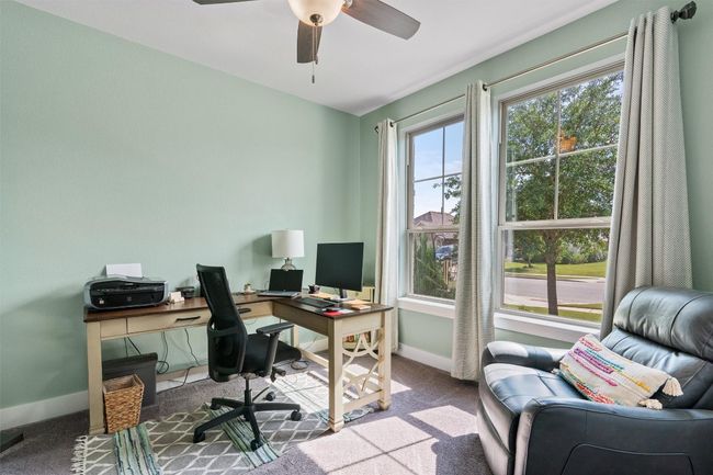 Carpeted home office with baseboards and a ceiling fan | Image 21