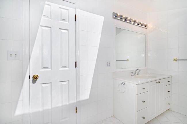Bathroom featuring tile patterned floors, tile walls, and vanity | Image 20
