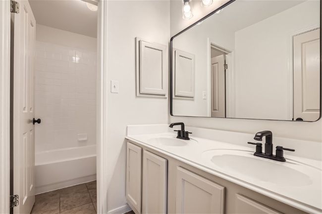 Bathroom featuring double vanity and shower / tub combination | Image 33