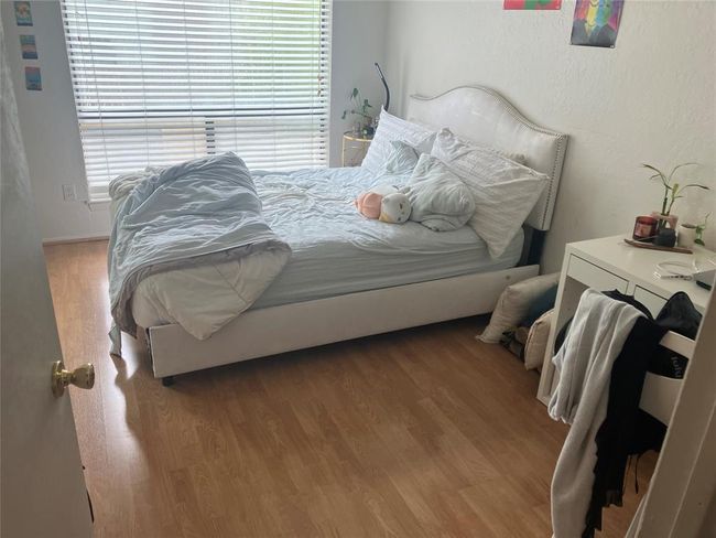 Bedroom featuring multiple windows and wood finished floors | Image 9