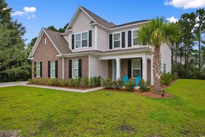 Craftsman-style home with a front yard and a porch | Image 2