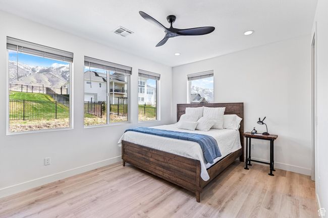 Bedroom with ceiling fan, light wood-style flooring, visible vents, recessed lighting, and baseboards | Image 51