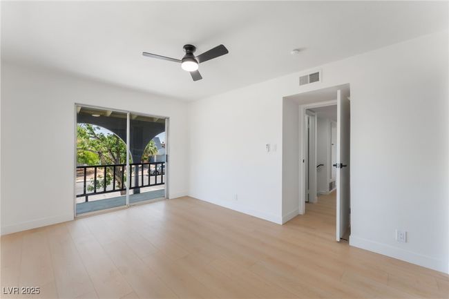 Empty room with ceiling fan and light wood-style floors | Image 28
