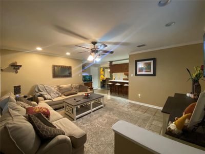 Living room featuring ceiling fan and crown molding | Image 3