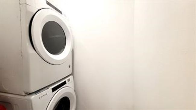 Laundry room featuring stacked washer / drying machine | Image 11