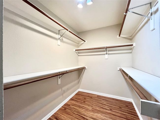 Spacious closet featuring wood finished floors | Image 17