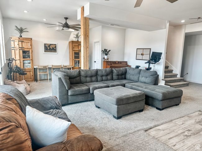 Carpeted living room featuring visible vents, ceiling fan, and recessed lighting | Image 24