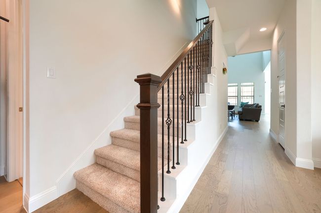 Staircase featuring baseboards, wood finished floors, and recessed lighting | Image 24