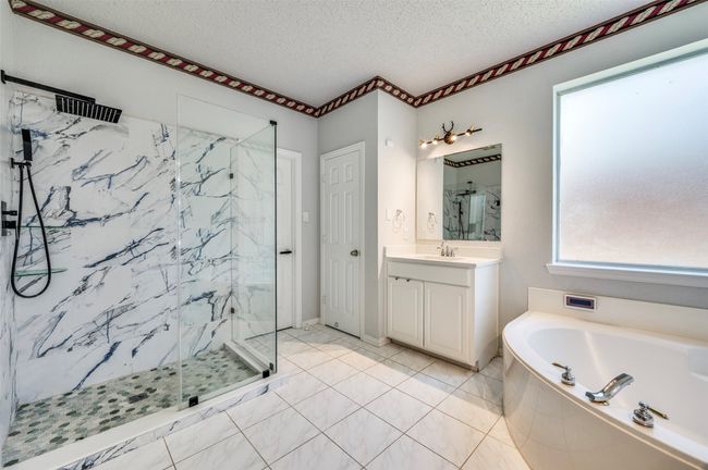 Master bath with standing shower & tub, his sink, master closet & linen closet | Image 14