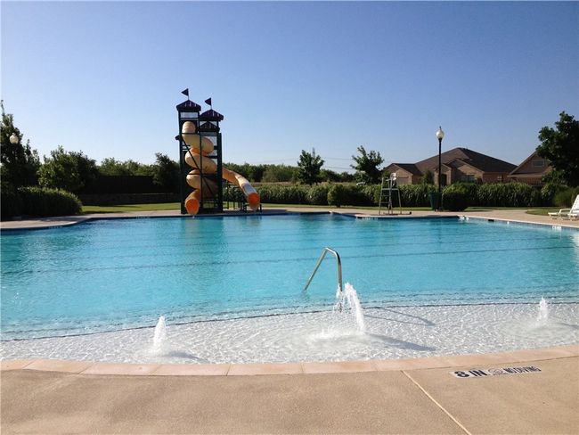 Community pool featuring a water slide | Image 17