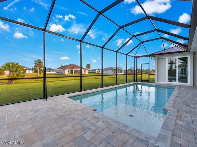 Swimming pool with a lawn, a patio area, and glass enclosure | Image 32